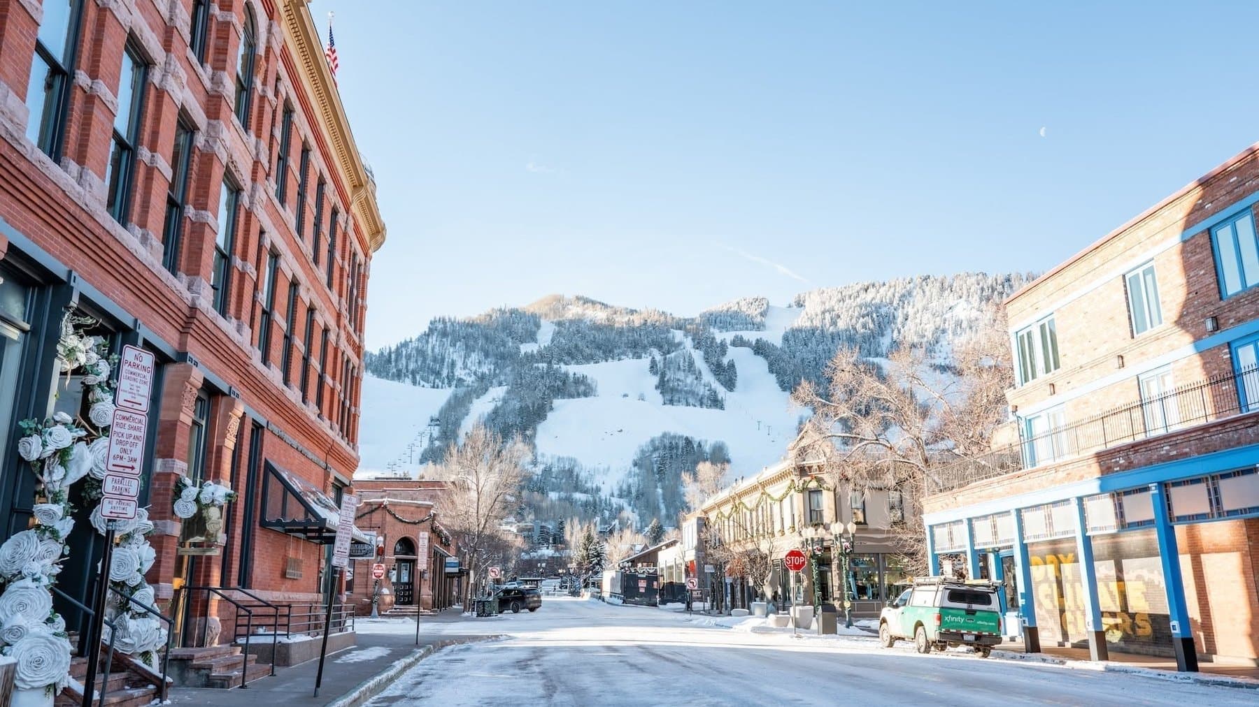 A snowy street in downtown Aspen with Aspen Mountain rising at the end
