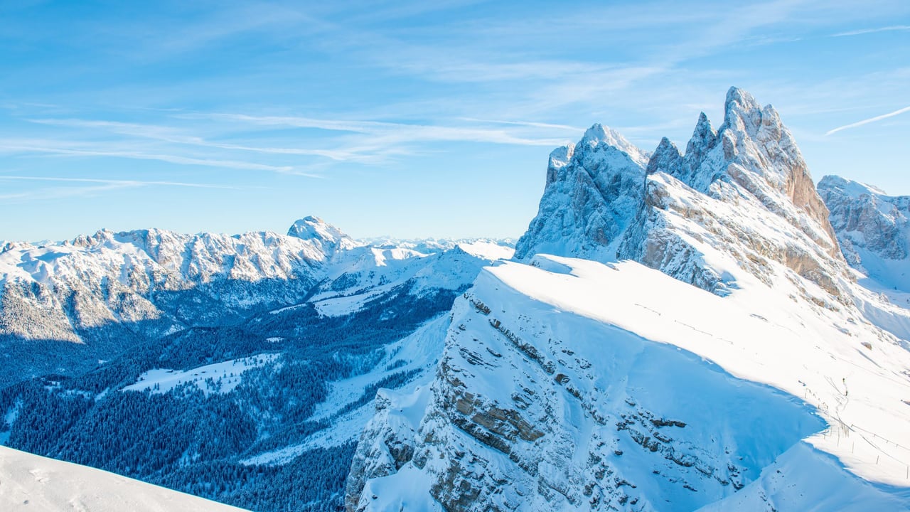 Jagged Dolomite rock spires above a snow covered ridge near Cortina d'Ampezzo