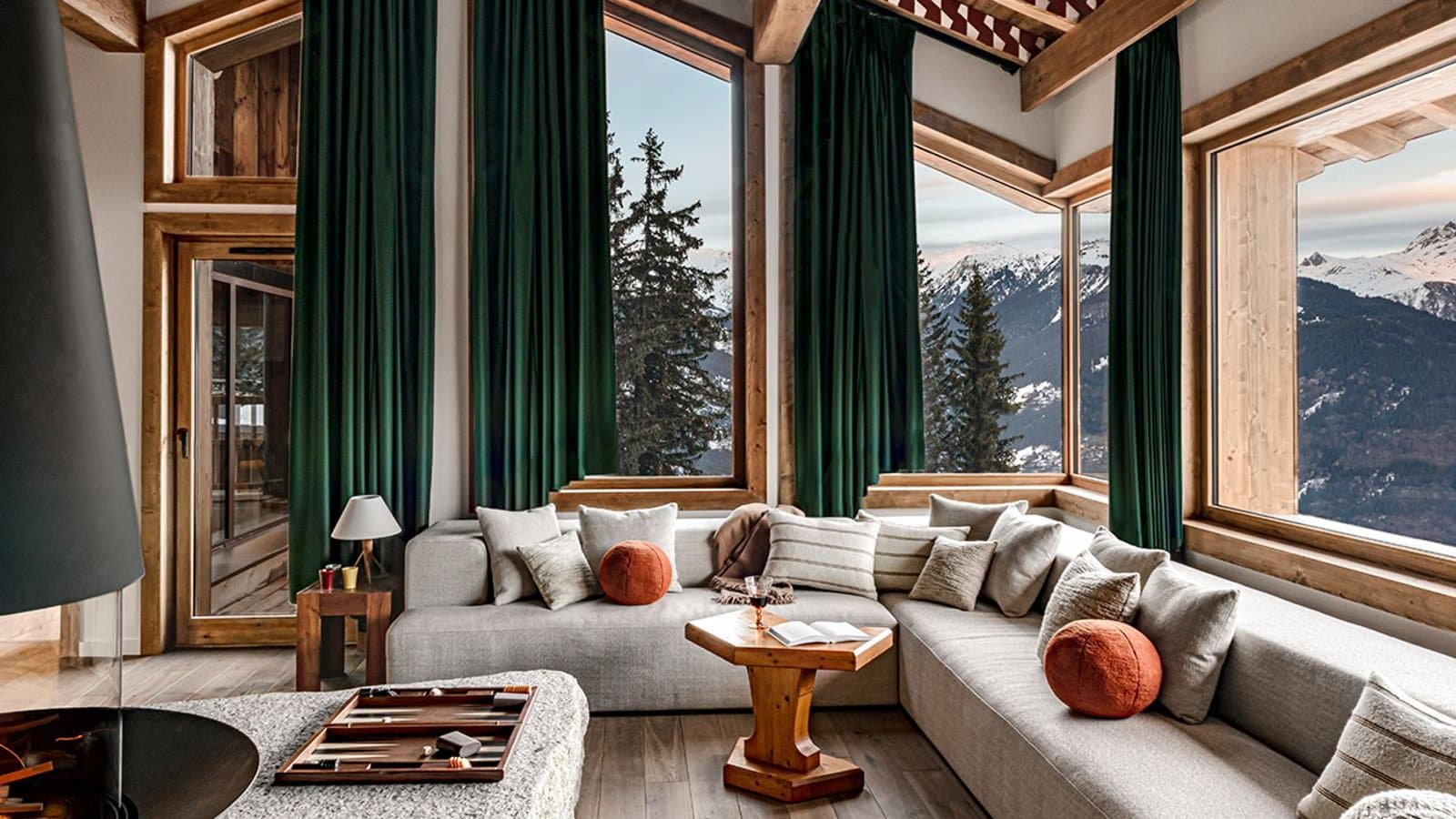 A chalet living room with tall windows onto the Alps in Courchevel