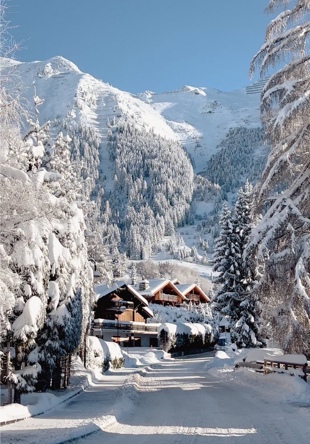 Alpine village below snow-covered peaks